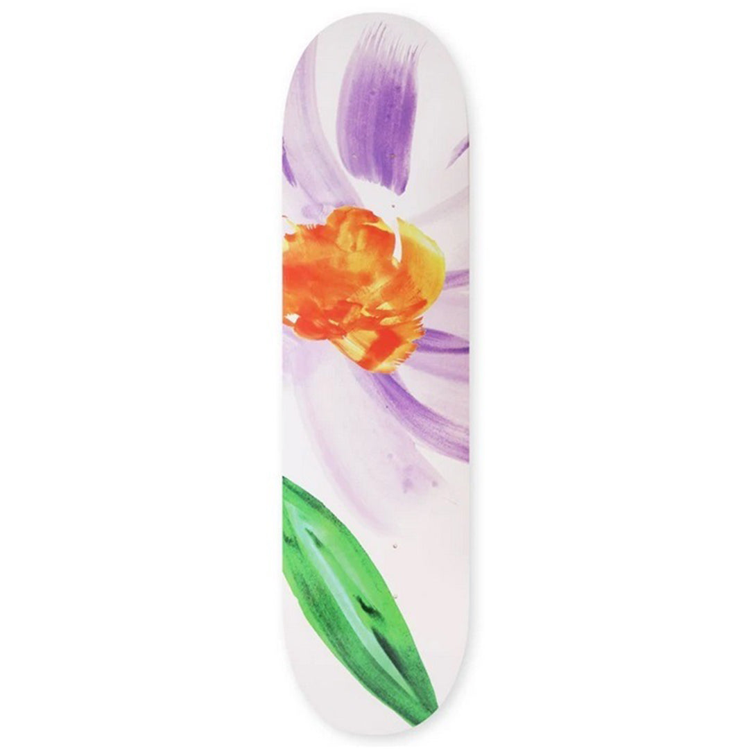 A skate Cafe skateboard deck featuring a watercolor-style floral design with purple petals, a bright orange and yellow center, and a green leaf on a white background.